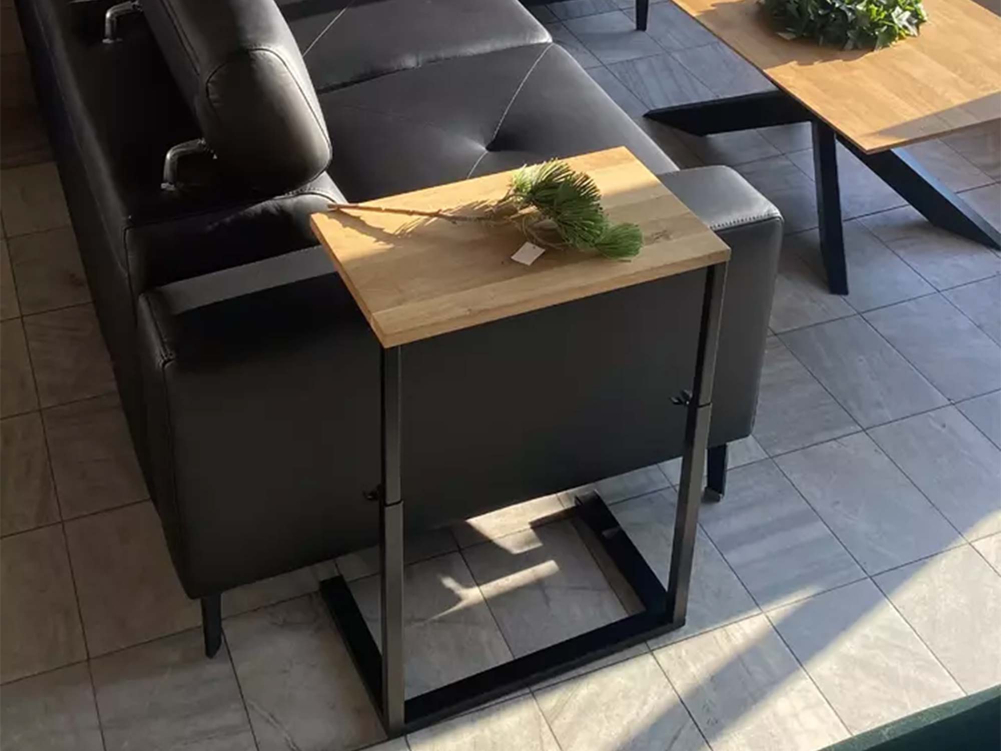 Stolik pomocniczy dębowy przy skórzanej sofie w salonie loft